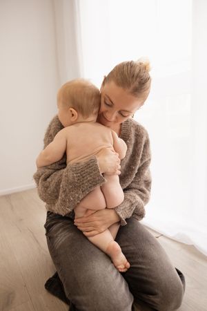 Milestone session in the studio, toddler cuddling mum