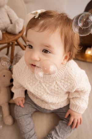 toddler sitting and staring during studio milestone session in Christchurch