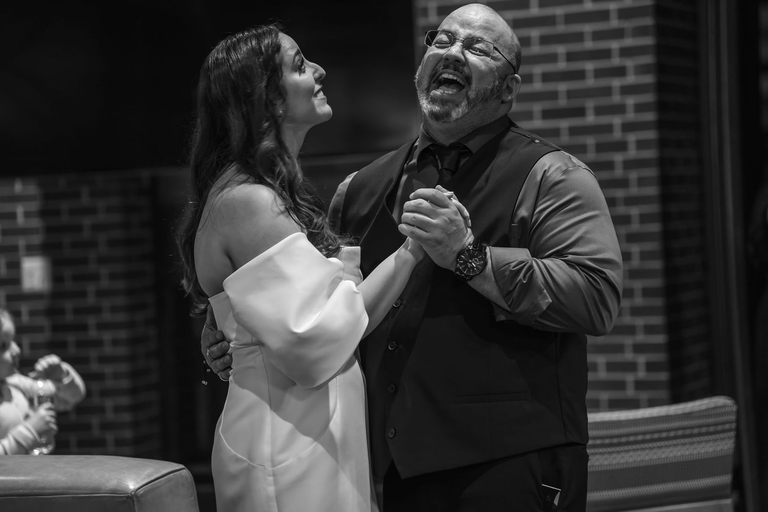 Black-and-white candid of couple during wedding near brick wall | DC wedding photographer