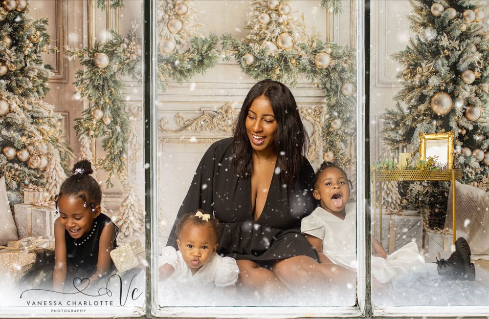 Beautiful holiday family portrait with winter decorations and artificial snow.