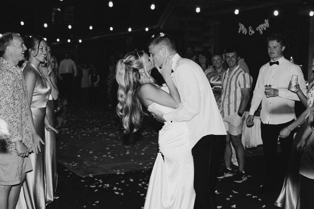 Black and white photographs of people dancing together in formal attire at an evening event.