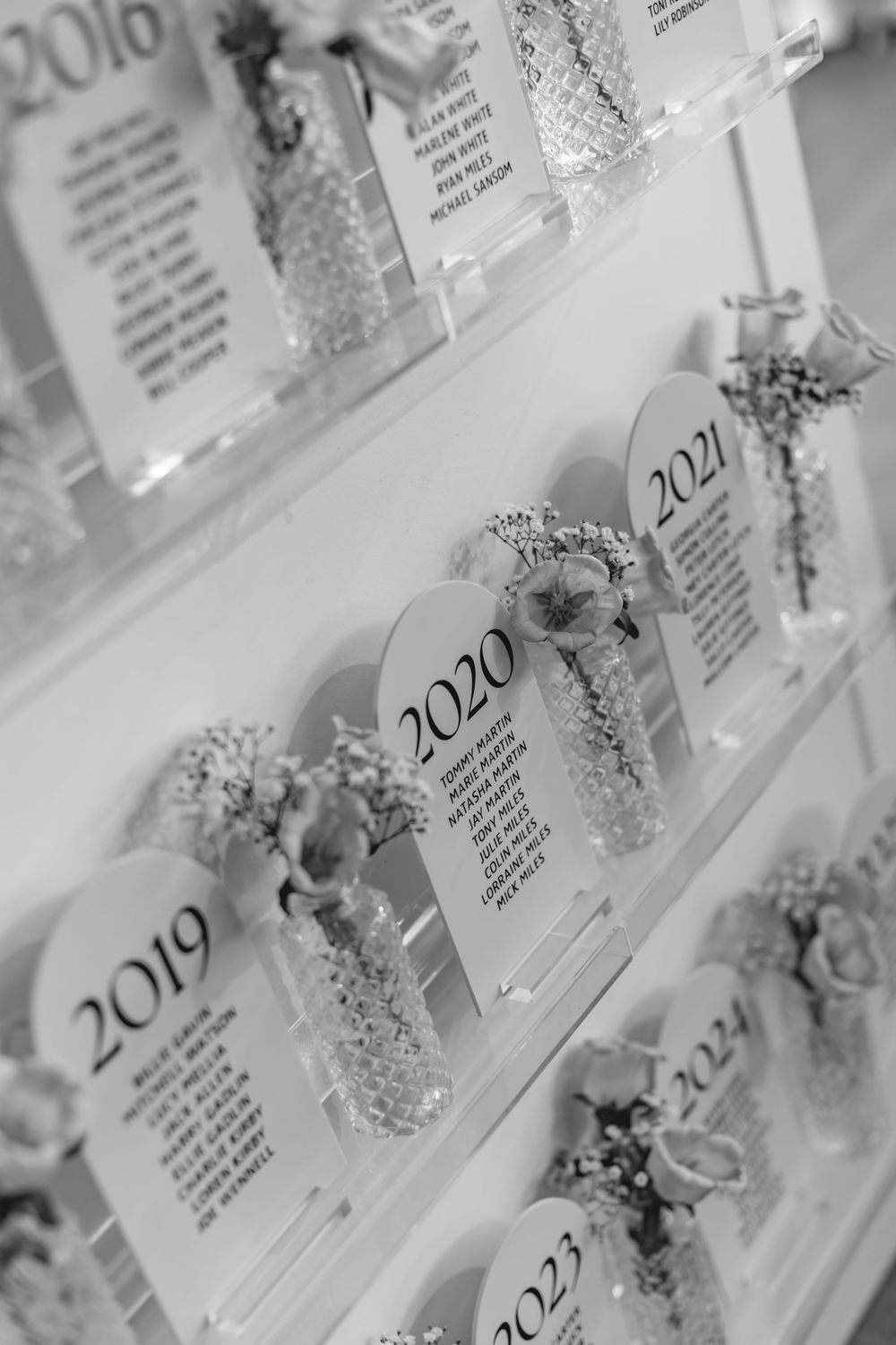 Wedding seating chart display with years labeled from 2019-2022 in an elegant silver and white design.