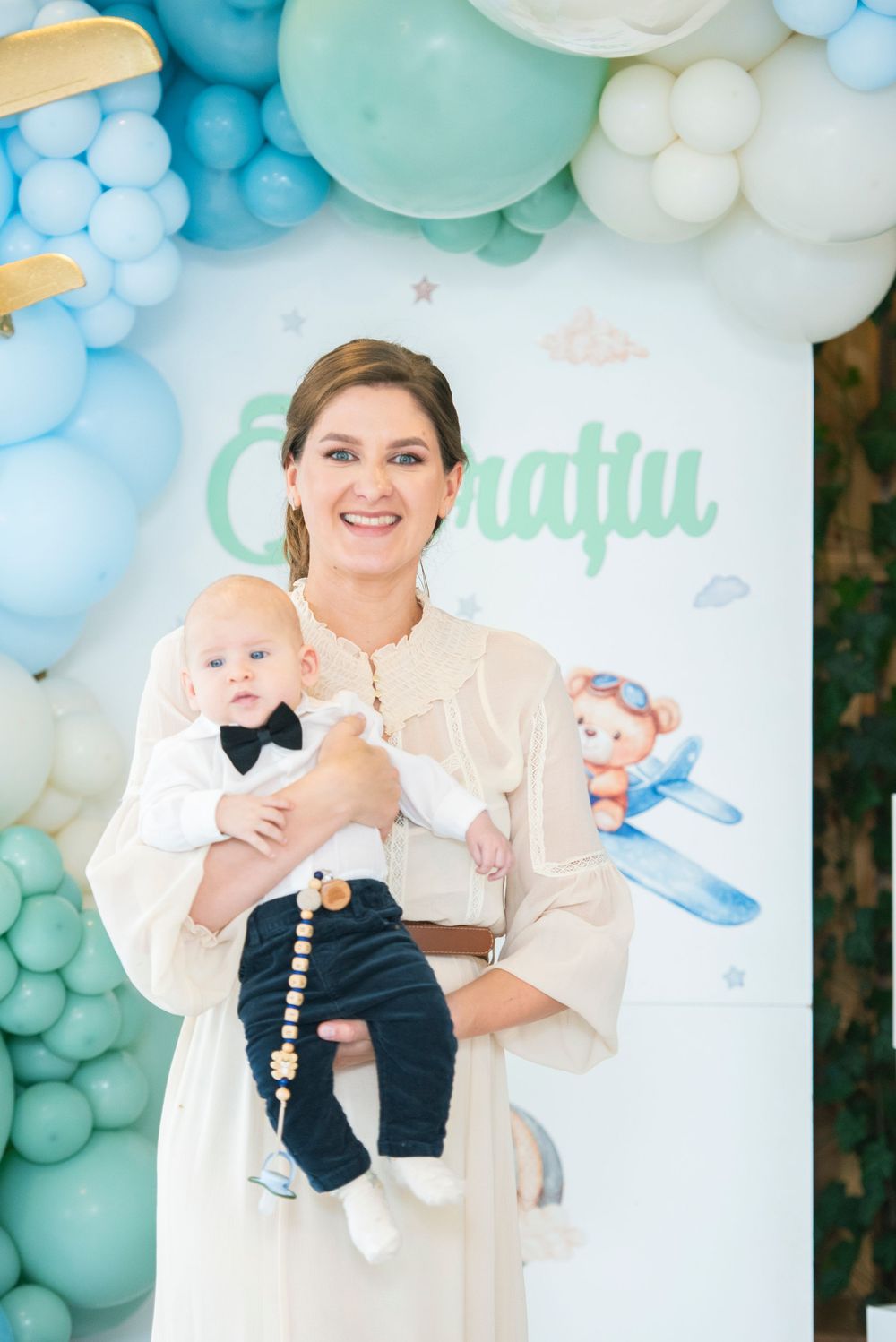 A baby shower celebration with blue and white balloon decorations and festive party decor.