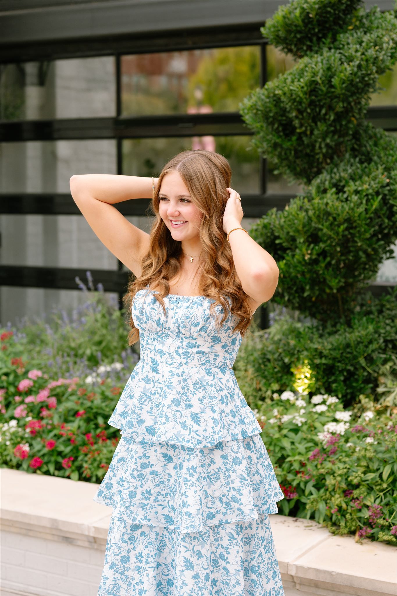 College Park High School girl posing for senior portraits in Market Street of The Woodlands, Texas