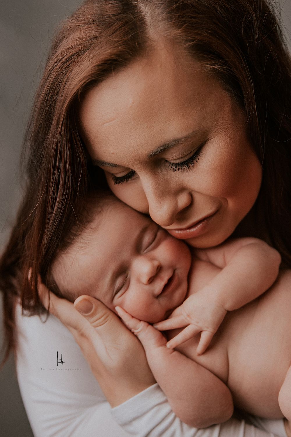 A tender series of intimate portraits showing a mother gently embracing and kissing her newborn baby.