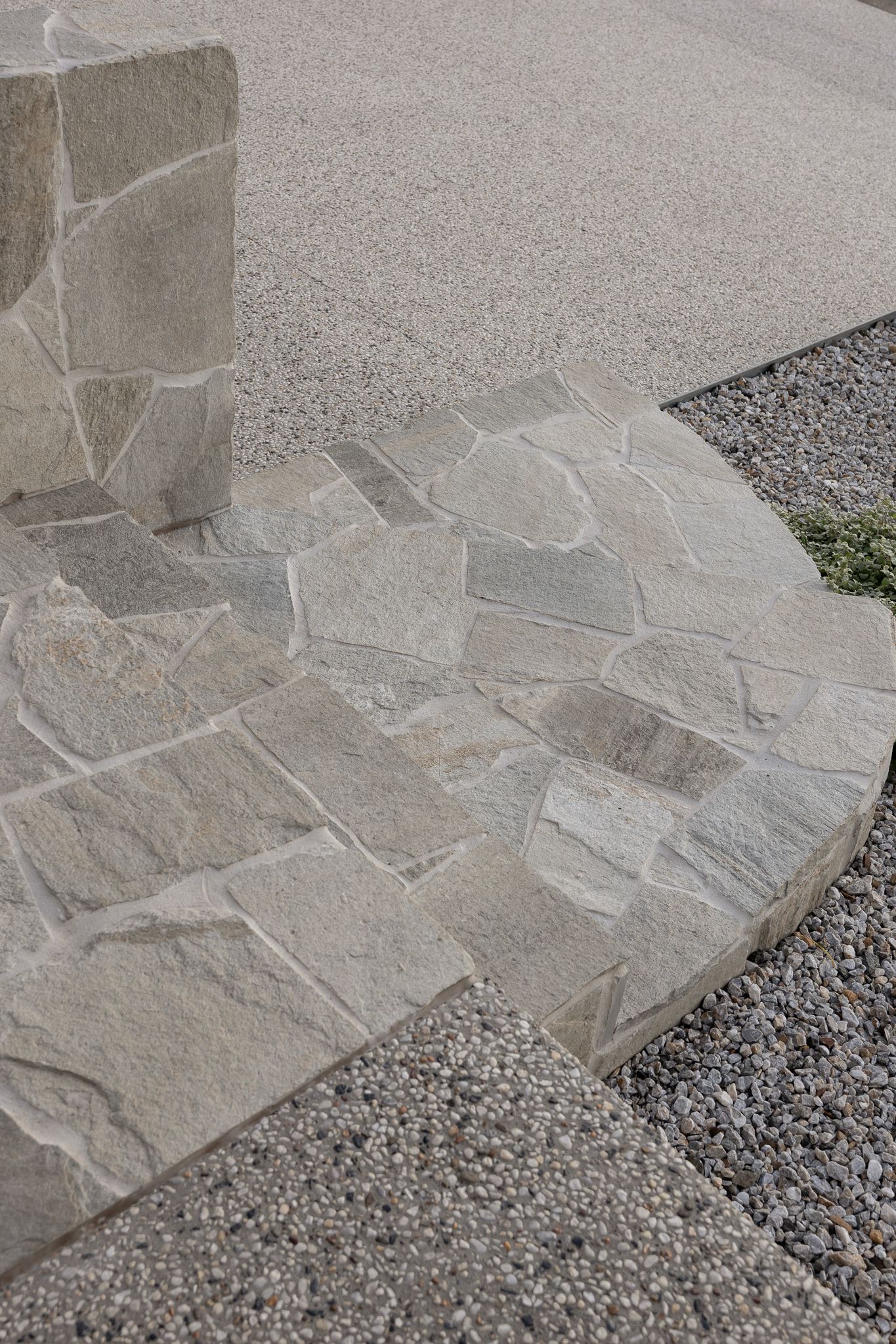 Close-up detail of natural stone paving with irregular patterns and textured surface.