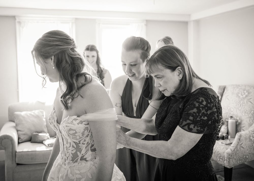 Black and white photo showing wedding preparation moments.