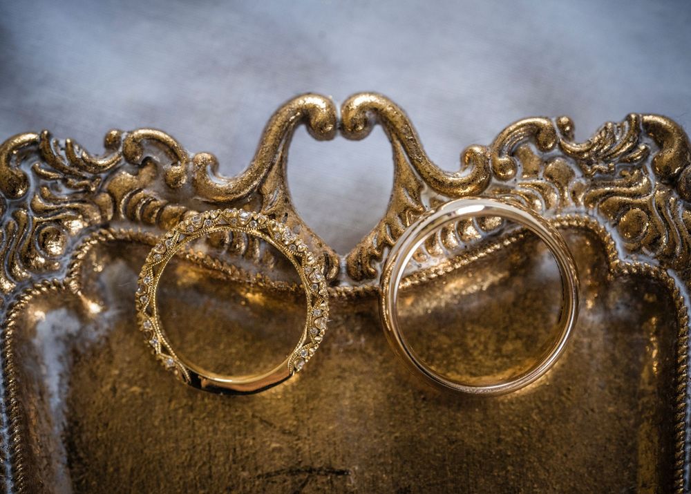 Ornate gold vintage headboard detail with intricate scrollwork patterns.