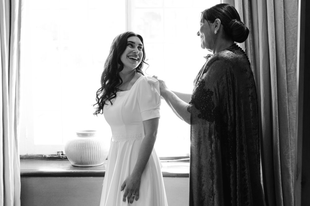 Black and white wedding photos showing candid moments of a bride and groom during their special day.