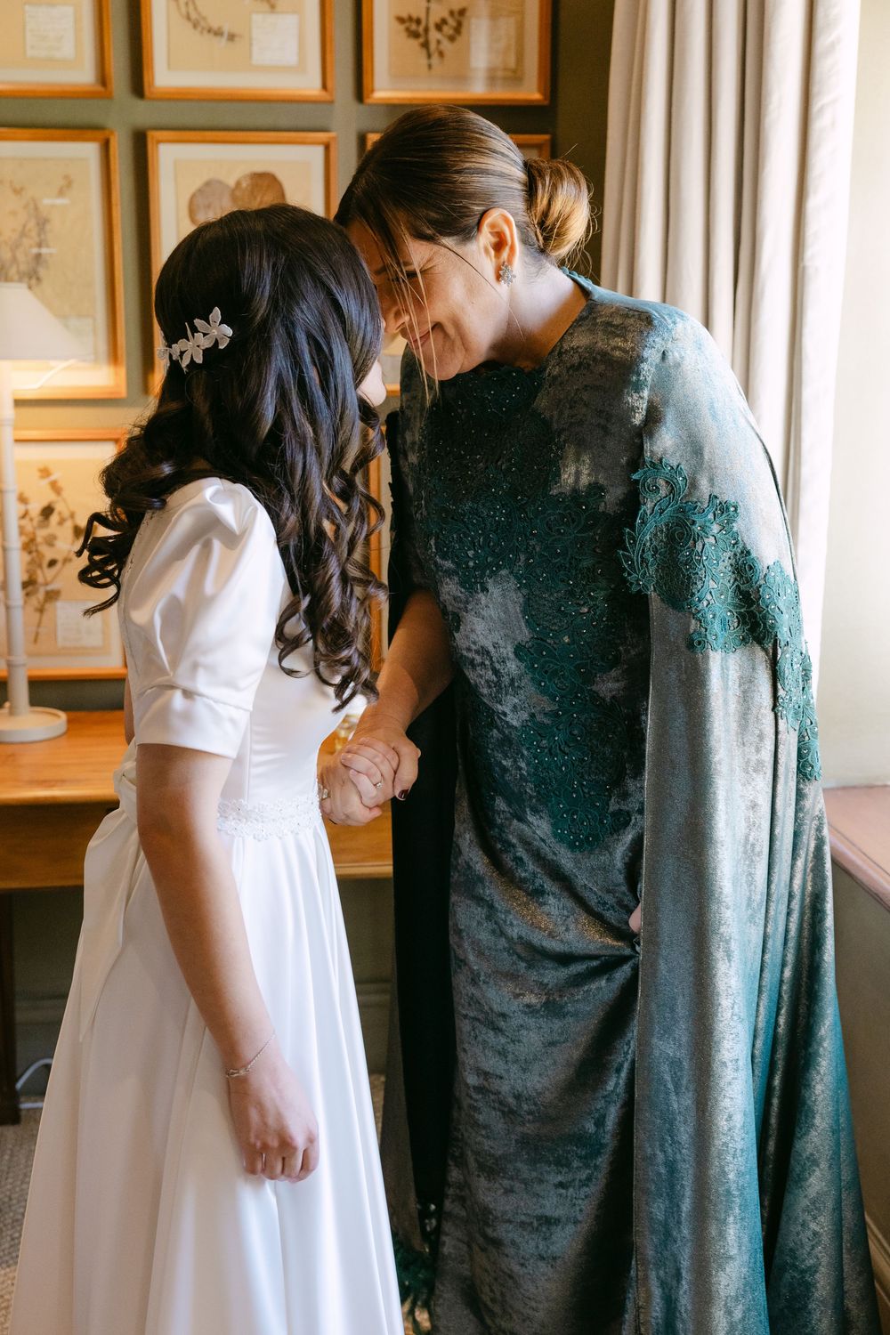 A romantic moment captured in an elegant room with vintage decor and beautiful natural lighting.