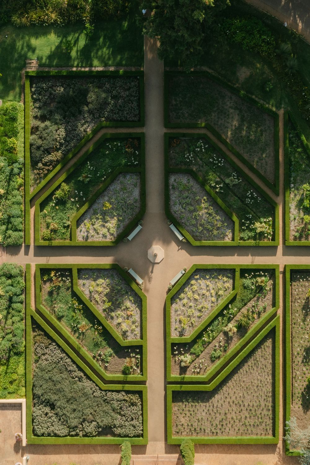 Aerial view of a symmetrical formal garden with octagonal pathways and manicured hedges.
