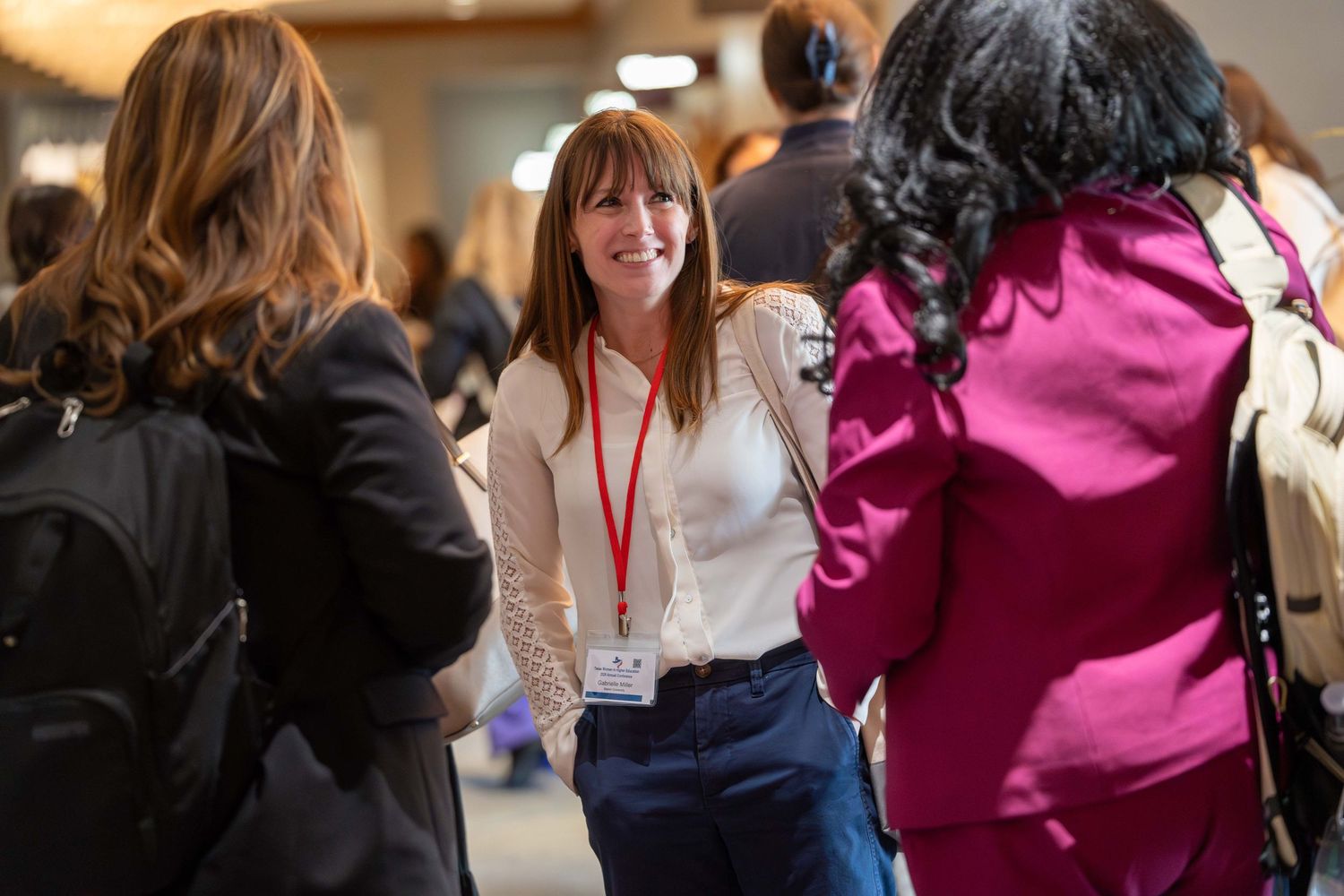 People networking and engaging in conversation at a professional conference or business event.