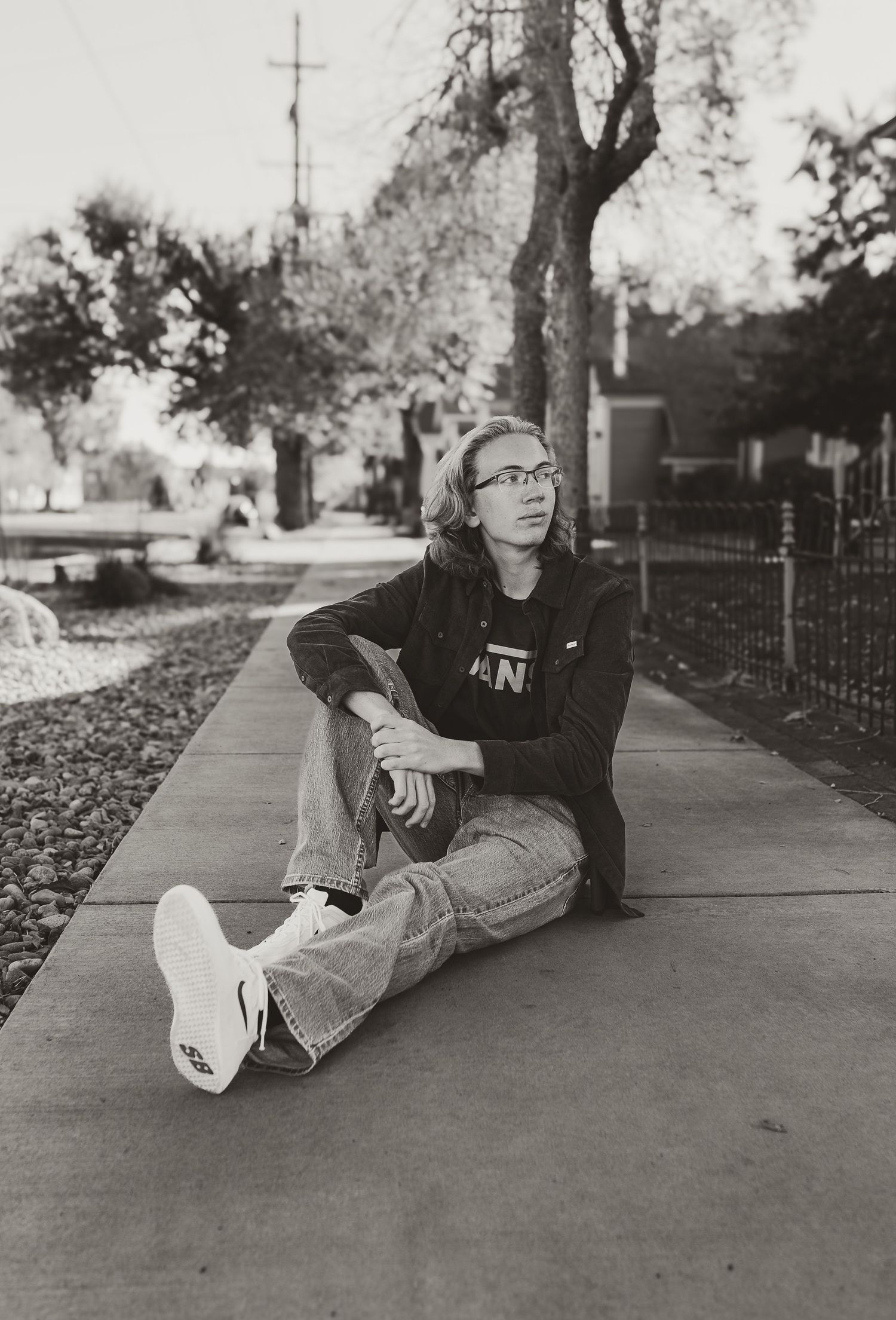 Black and white photo series showing person reclining on sidewalk in casual poses.