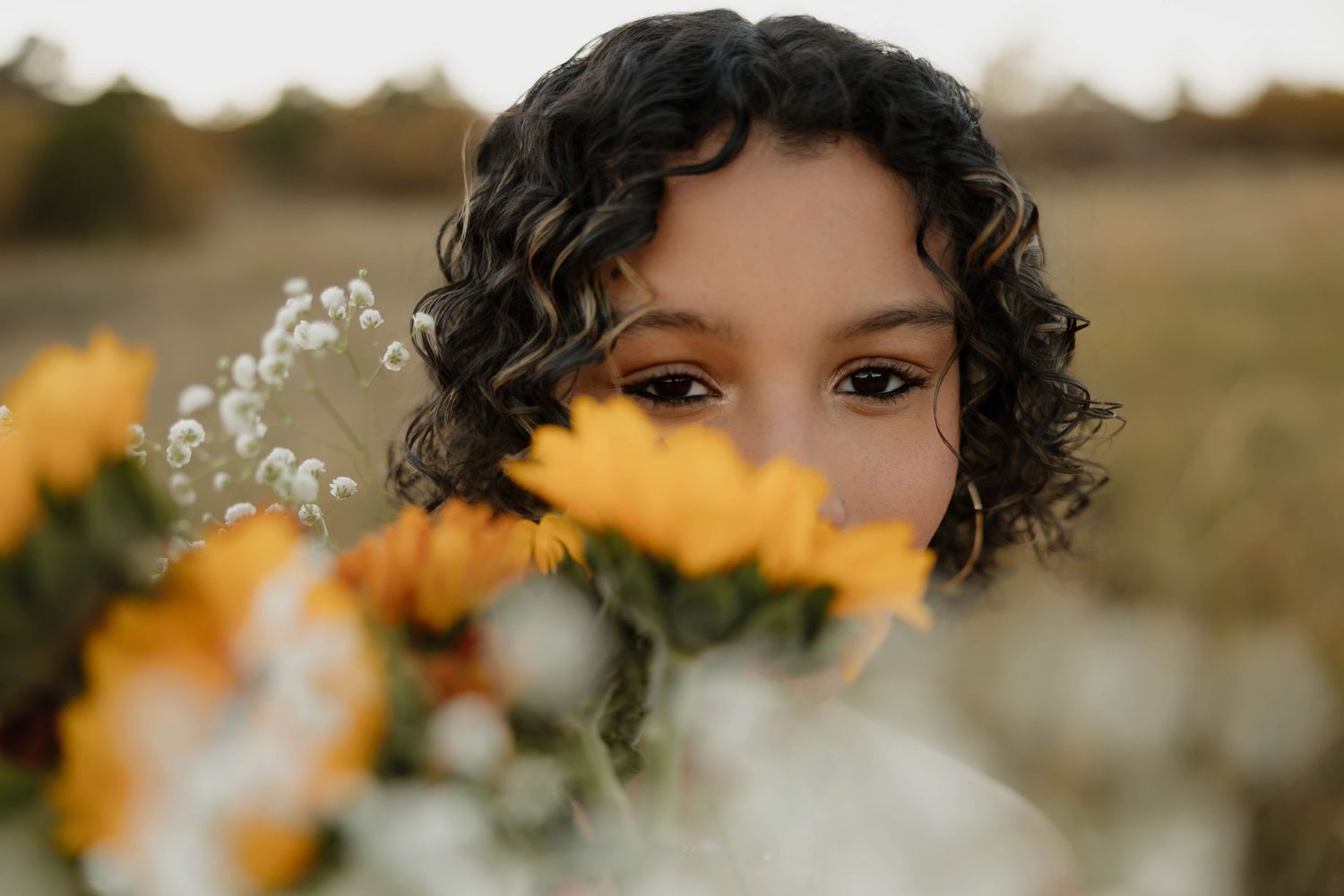 A series of outdoor portraits with sunflowers and wildflowers creating a warm, golden-hour aesthetic in nature.