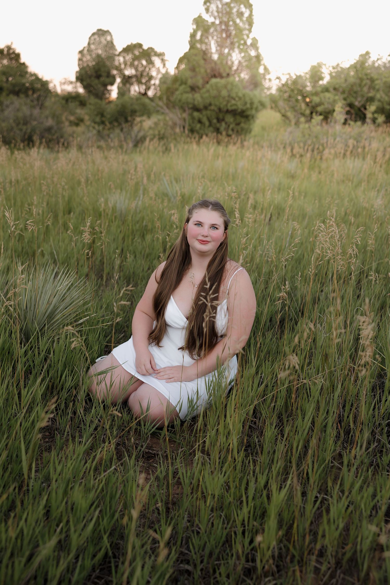 A series of photos showing someone sitting in tall grass during golden hour in a natural outdoor setting.