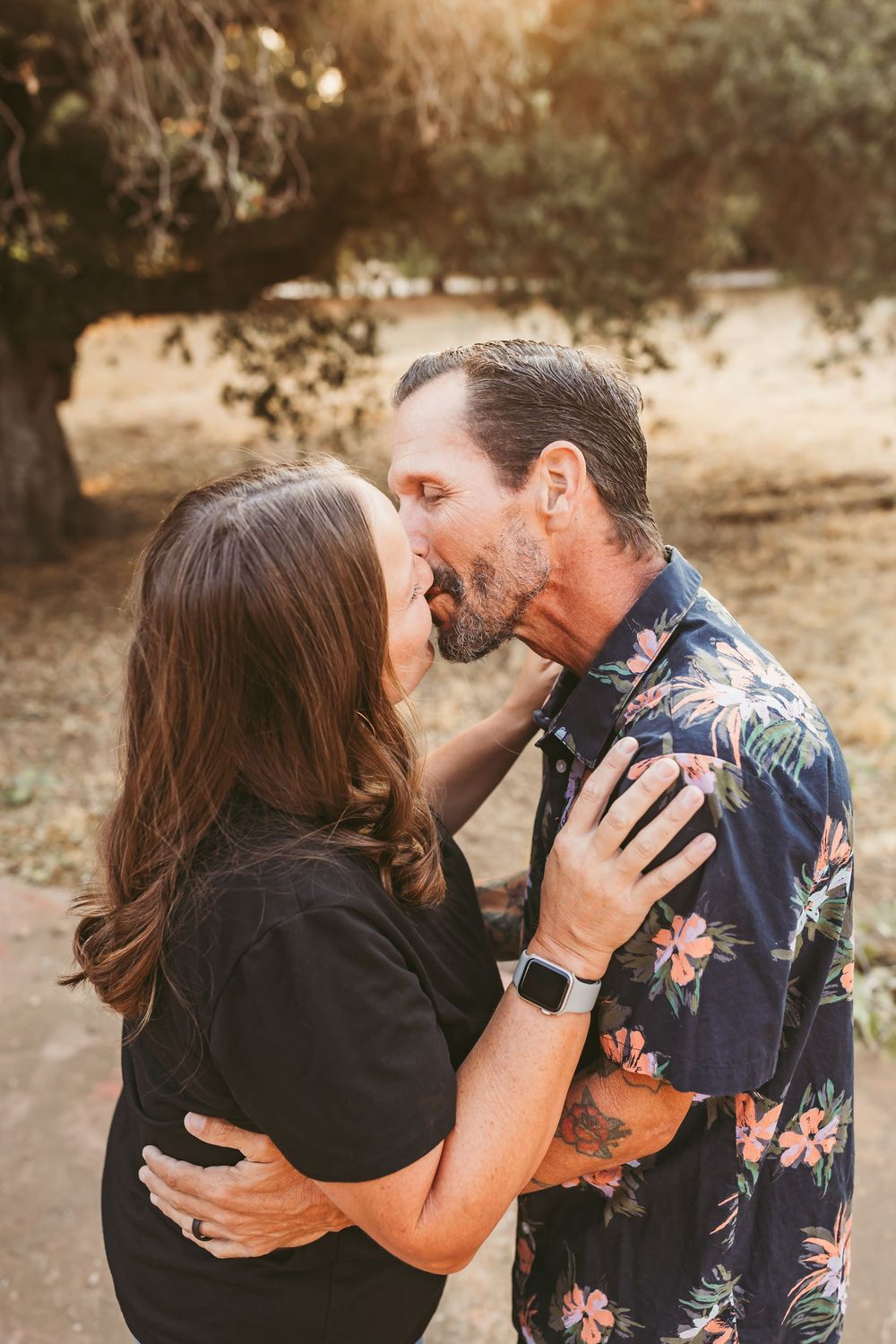 A romantic sequence of photos showing a couple sharing tender kisses in an outdoor setting during golden hour.