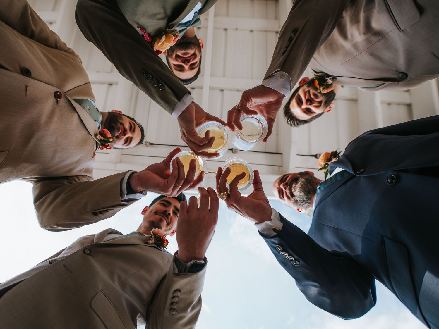 Groomsmen and Groom cheersing before the wedding