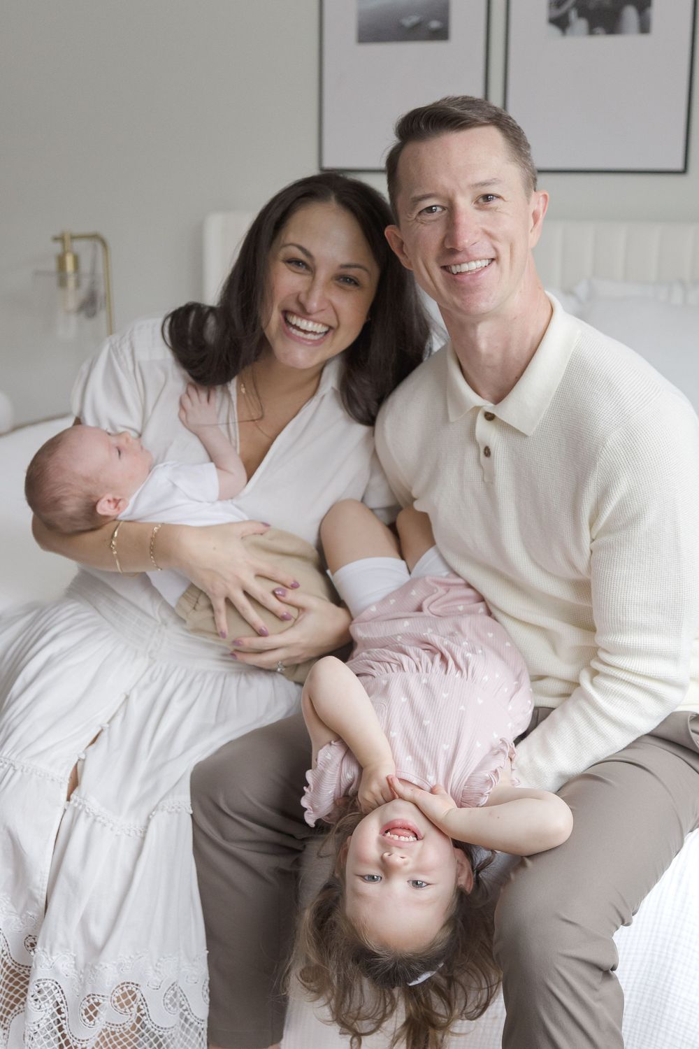 "Smiling family with newborn and playful toddler during in-home lifestyle photo session in Glover Park, Washington DC."