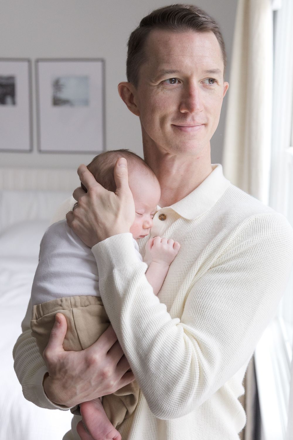 "Newborn baby sleeping peacefully on father's shoulder during elegant Washington DC lifestyle newborn session."