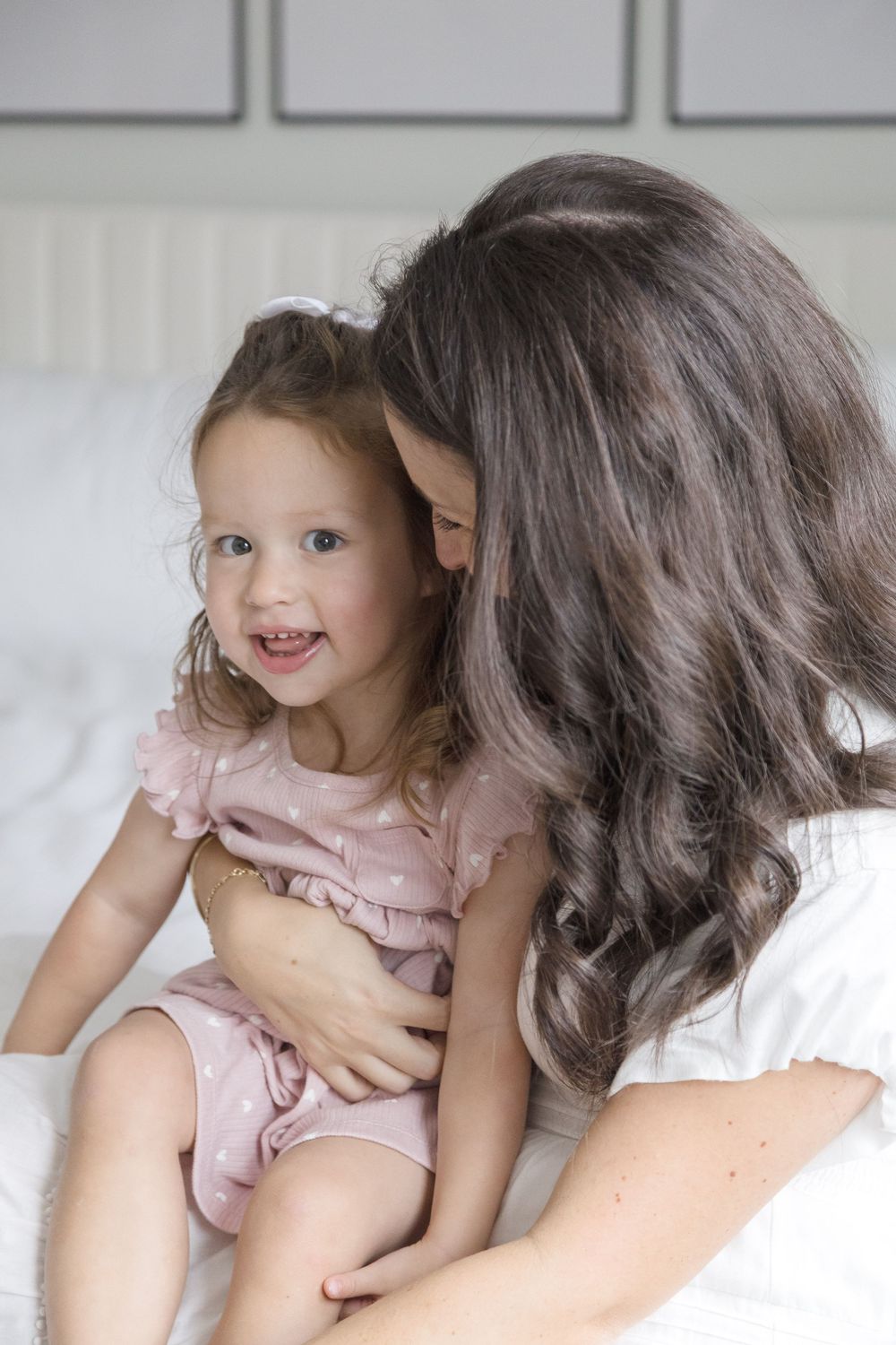"Mother holding cute toddler during in-home cozy lifestyle portrait session in Washington DC."