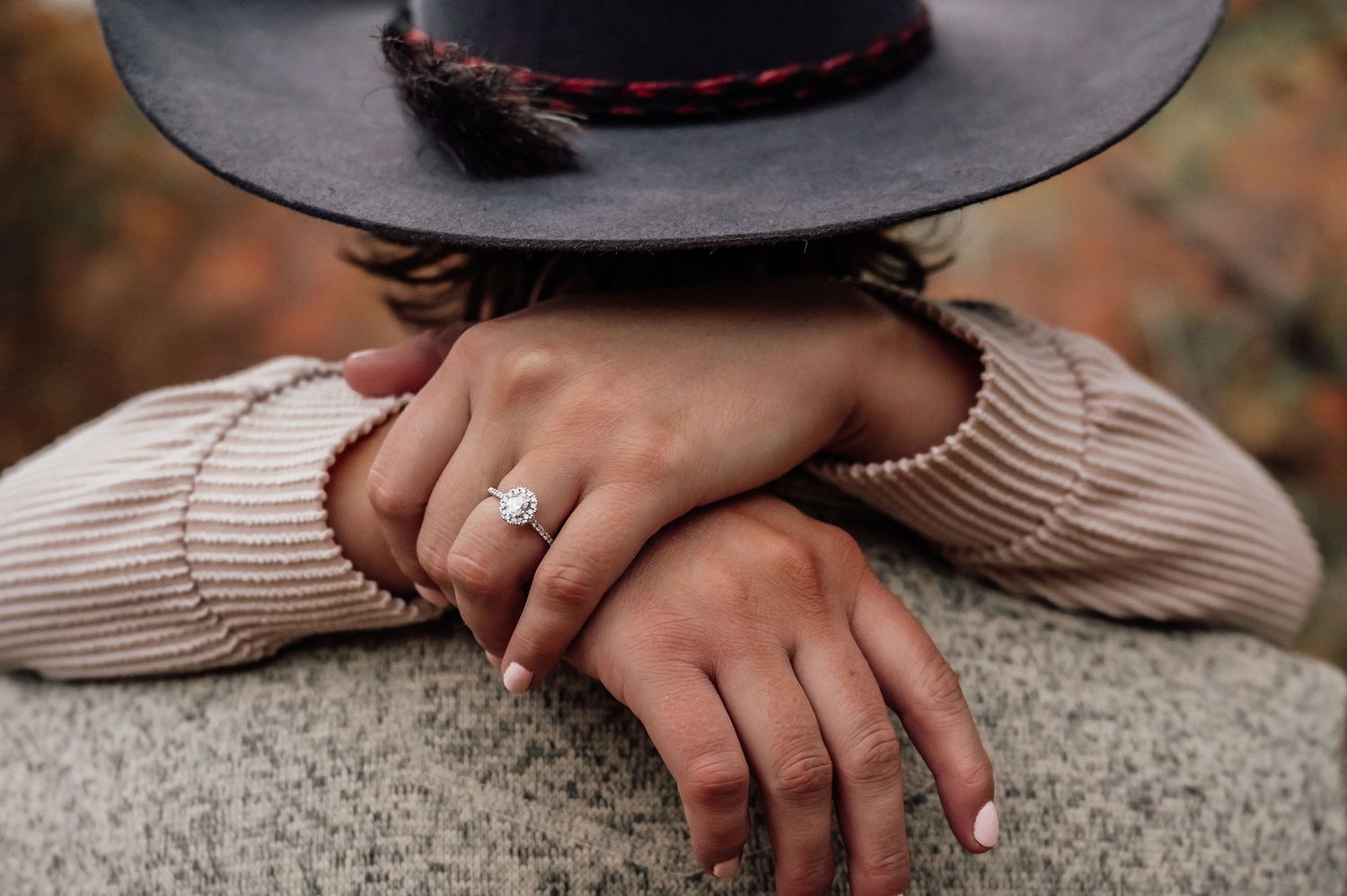Close-up detail of black felt hat with decorative band.
