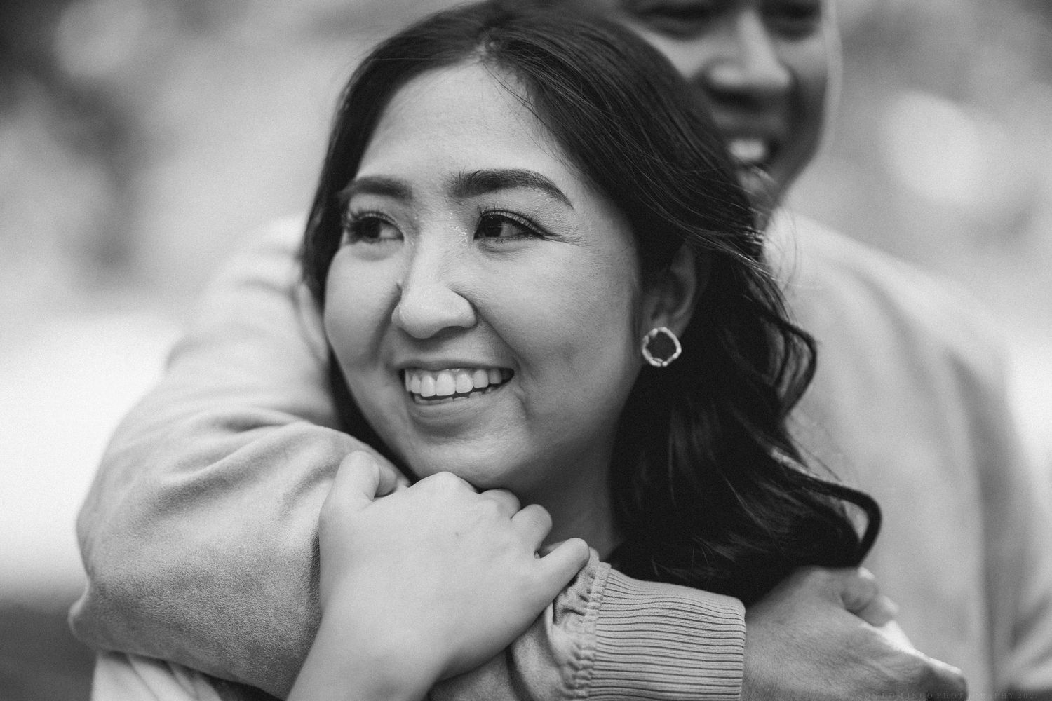 A collection of candid black and white photos showing joyful moments and laughter between people.