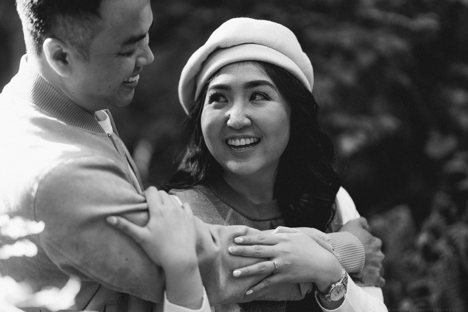 A romantic black and white photo sequence shows a couple embracing and dancing together outdoors.
