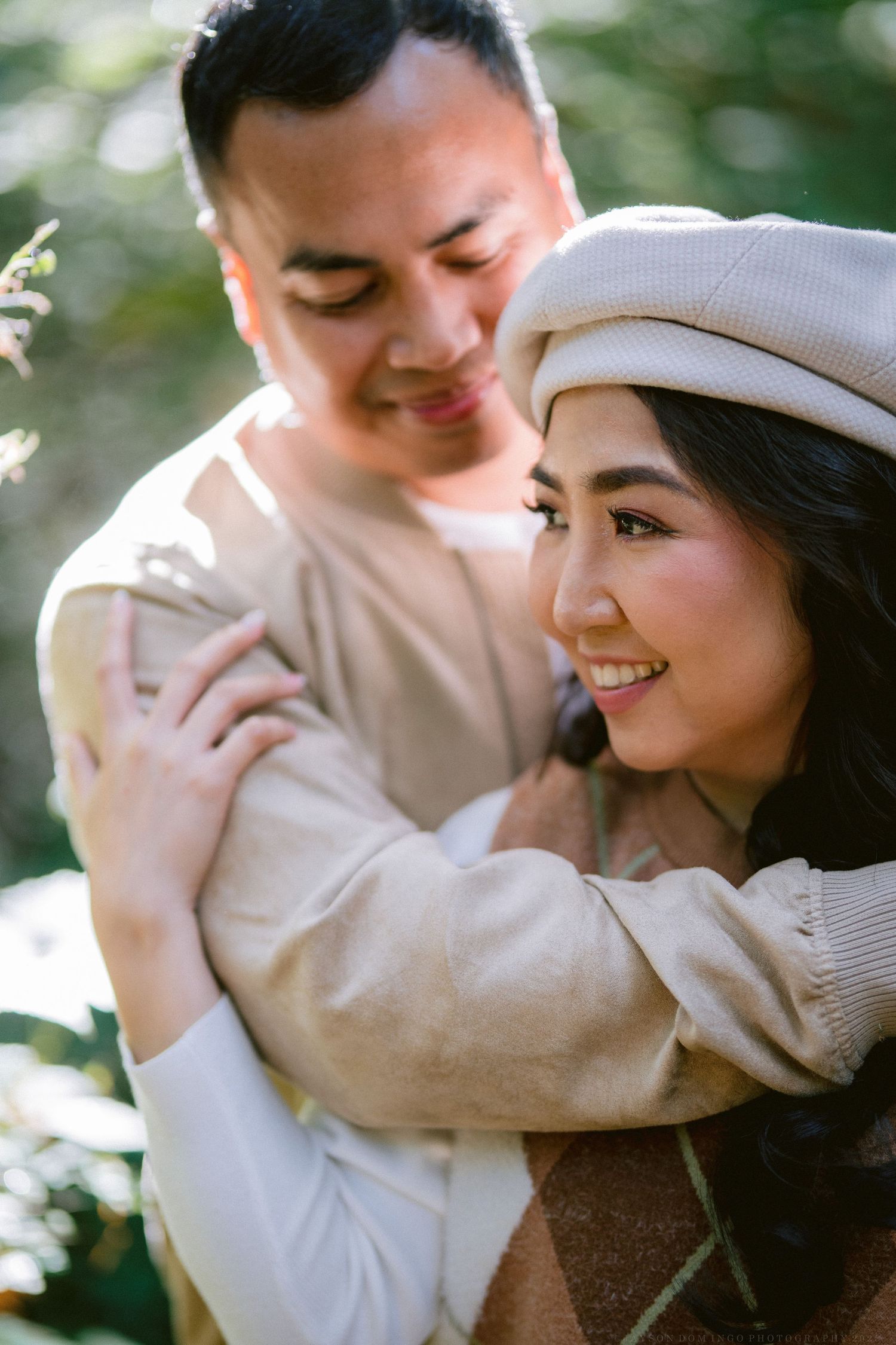 A romantic couple in neutral tones share tender moments in a series of intimate outdoor photos.