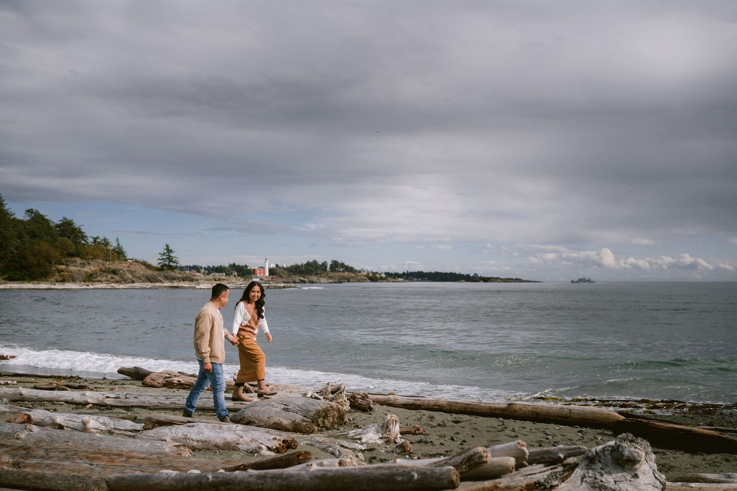 Scenic coastal landscape with rocky shoreline and overcast skies.