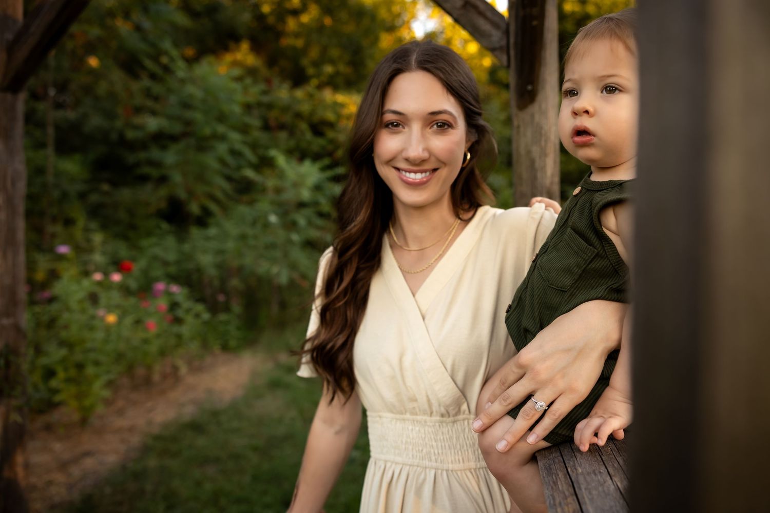 Mother and child sharing a playful moment in an outdoor evening setting.