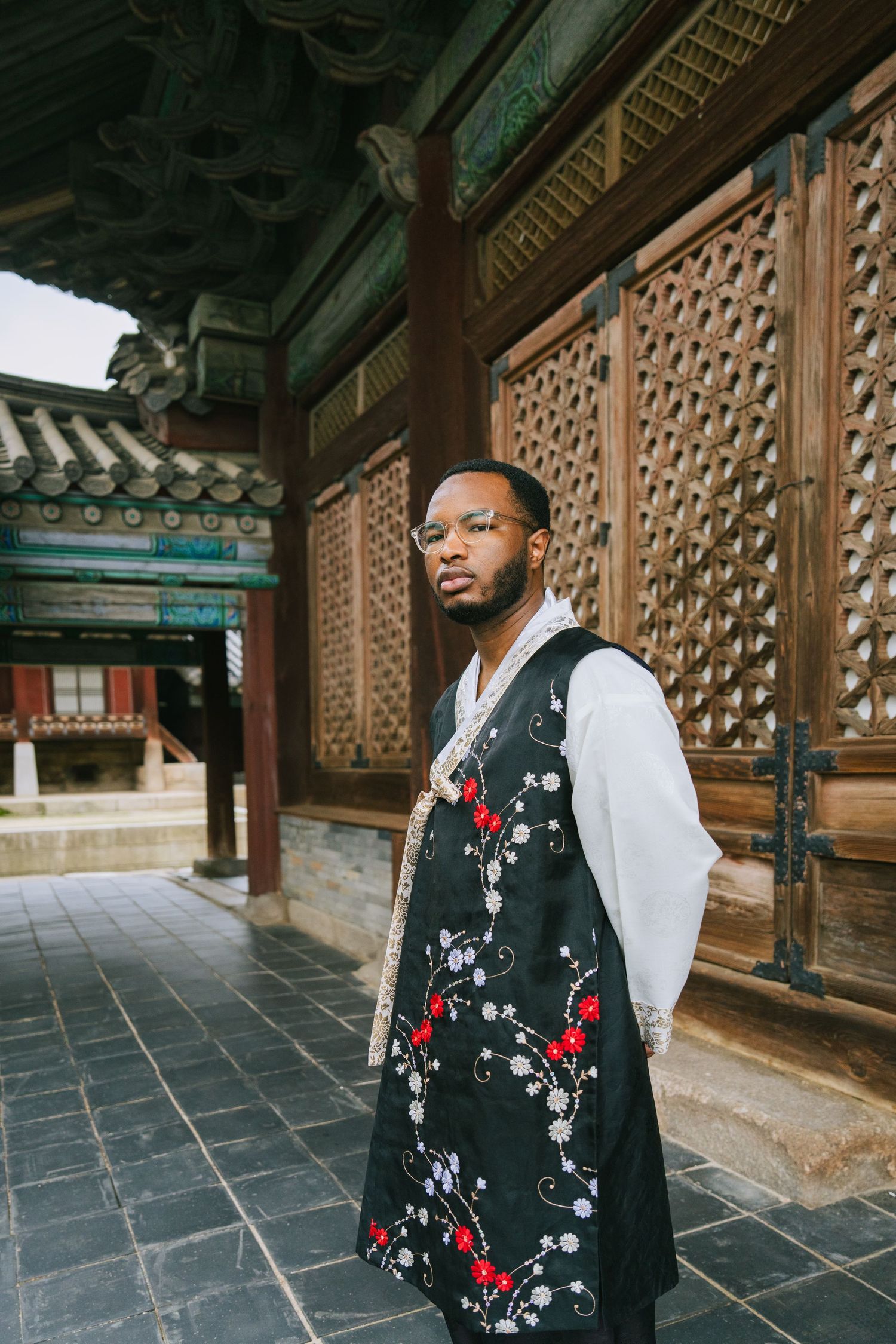 Traditional Korean palace architecture with ornate wooden lattice panels and stone walkways showcases cultural design details.
