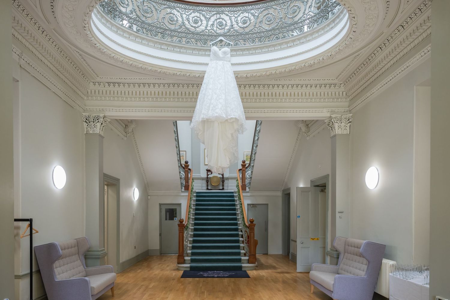 Grand interior hallway with ornate white moldings and elegant staircase.
