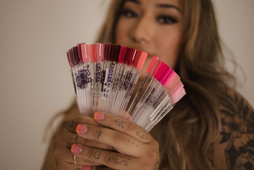 Displaying colorful nail polish samples in a fan arrangement.