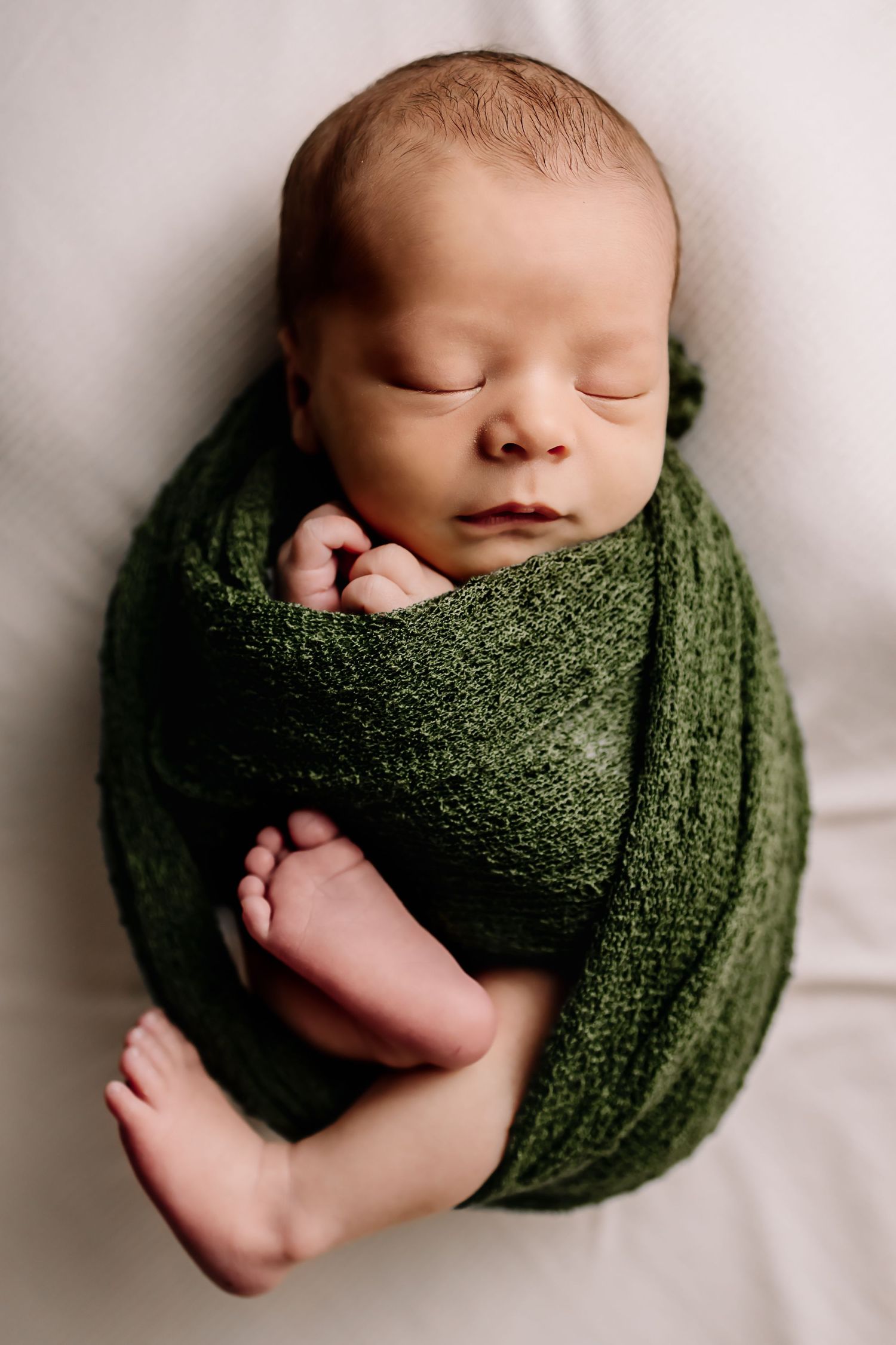 Newborn photographer in Richmond, Virginia. Maternity photographer near Richmond RVA. Baby Wrapped newborn session in studio