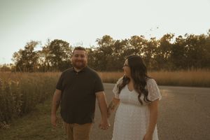 Romantic outdoor portrait session in a golden field at sunset.
