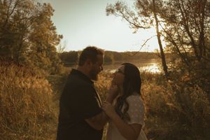 Silhouetted couple sharing an intimate moment at golden hour.