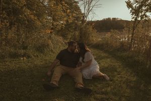 Romantic outdoor photoshoot in natural autumn landscape during golden hour.