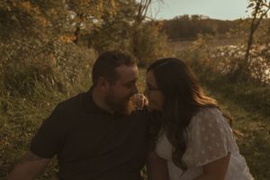 Couple sharing romantic moment outdoors in natural autumn setting.
