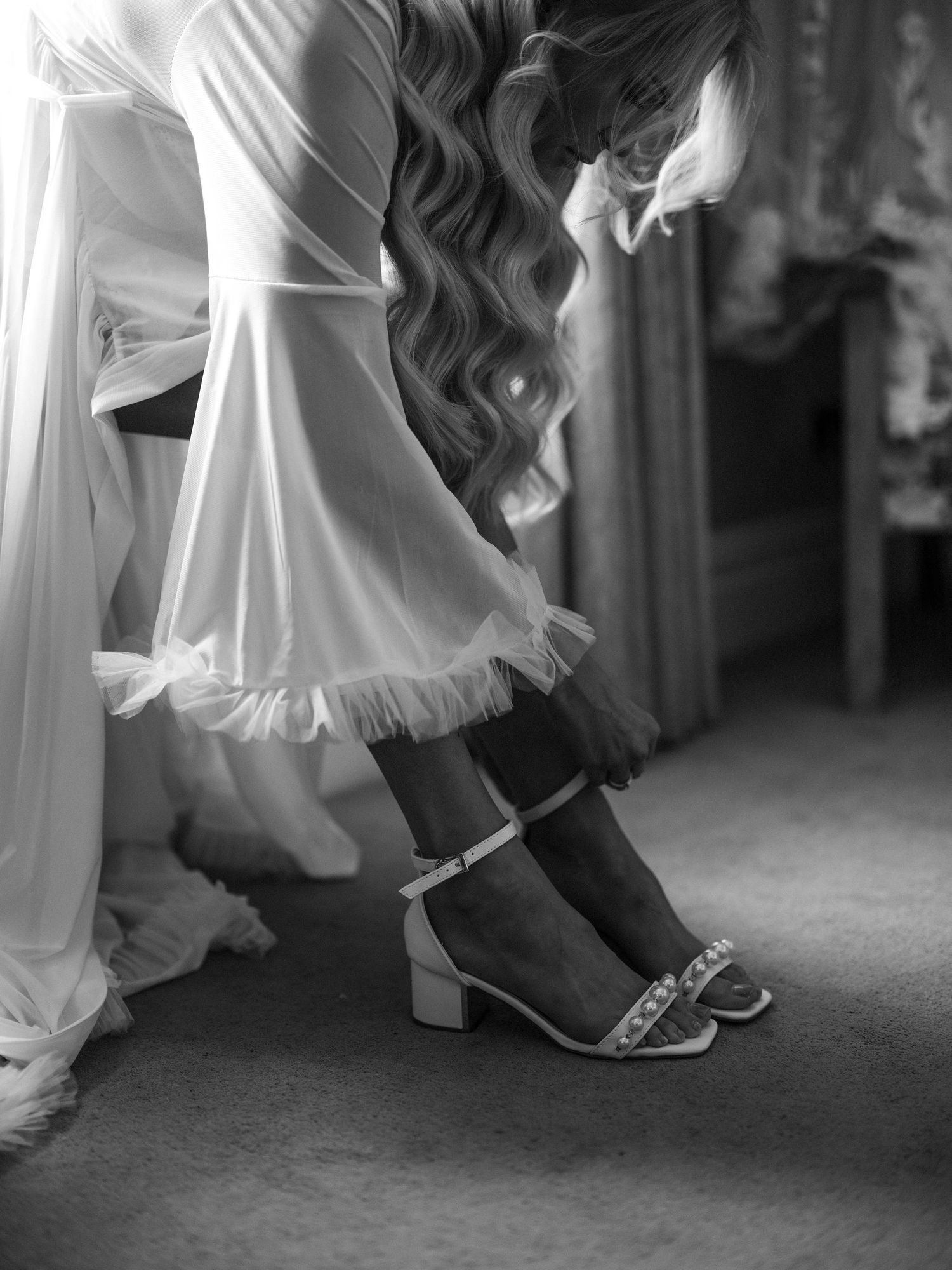 bride getting ready in black and white at Court Colman Manor