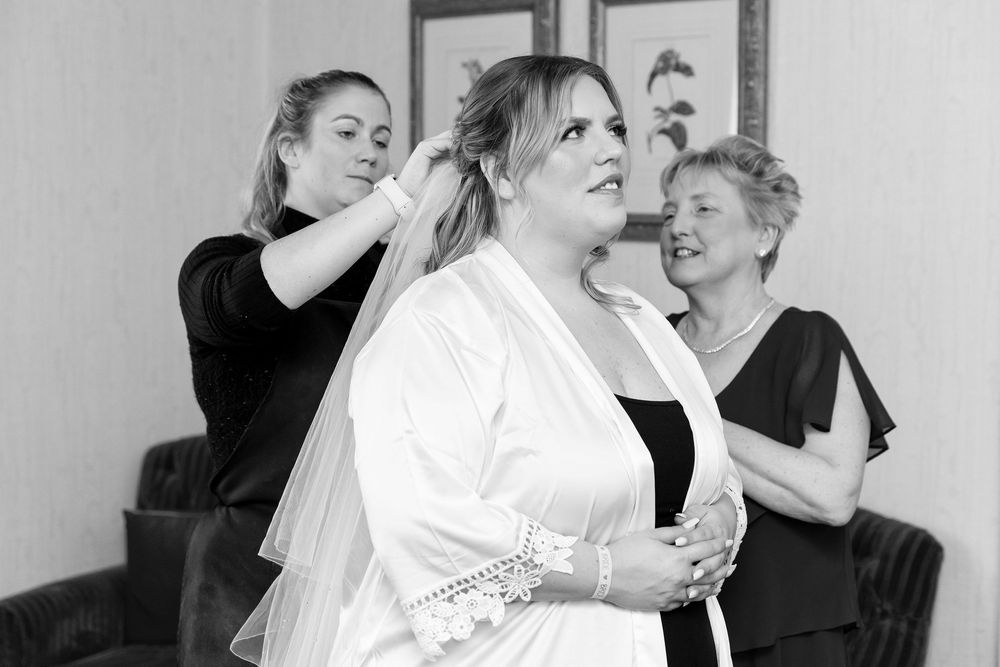 Bridal preparations with veil placement supported by family