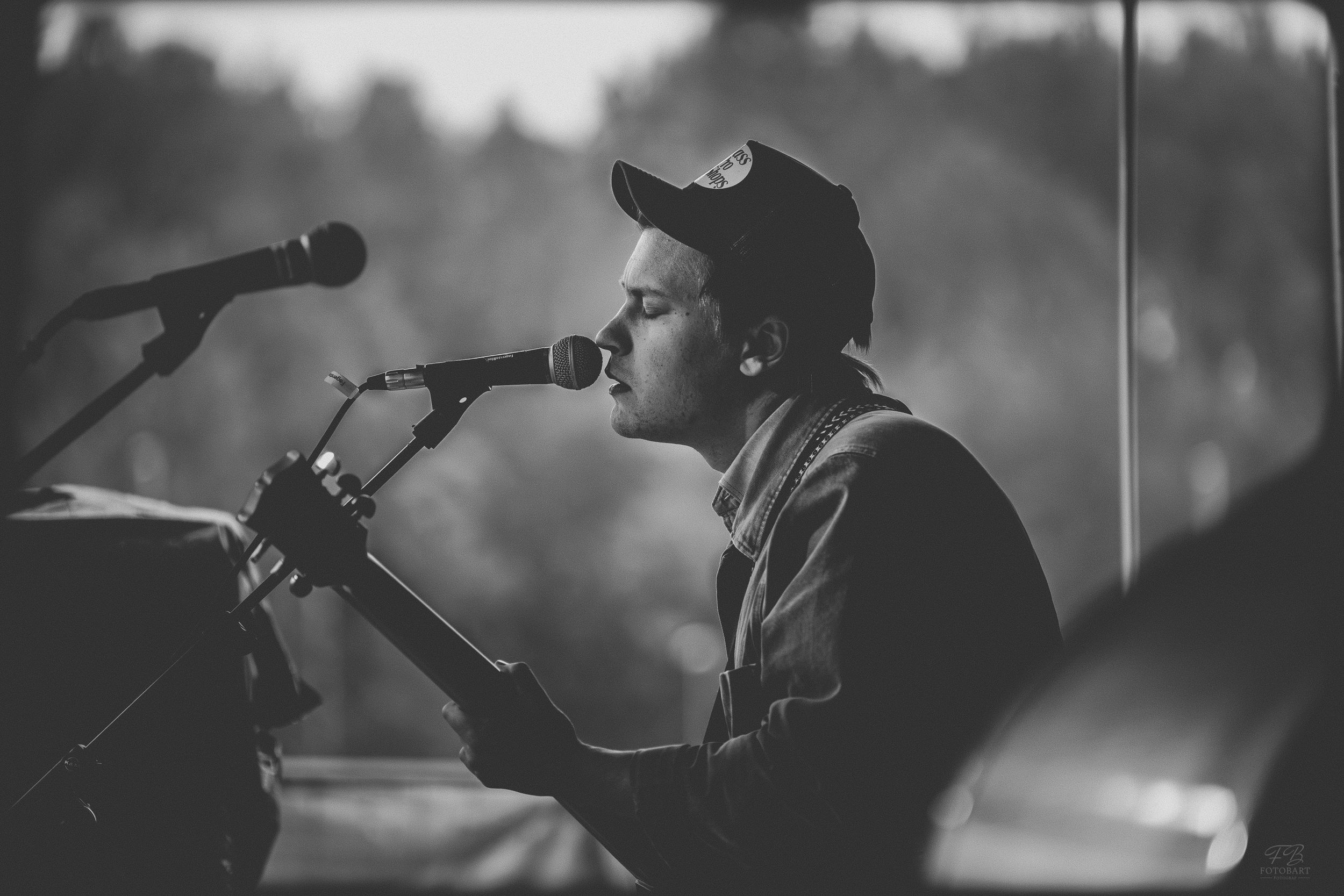 Live musician performing outdoors, captured in dynamic natural lighting. Perfect for event promotion, festival branding, and artist portfoli