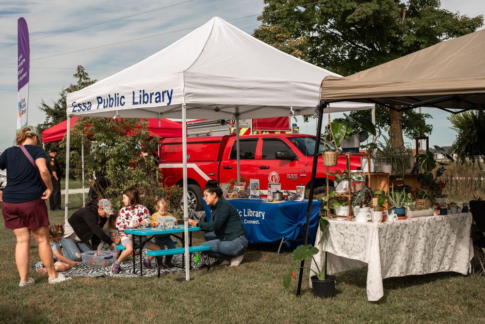 Public library booth with colorful displays at outdoor community event.