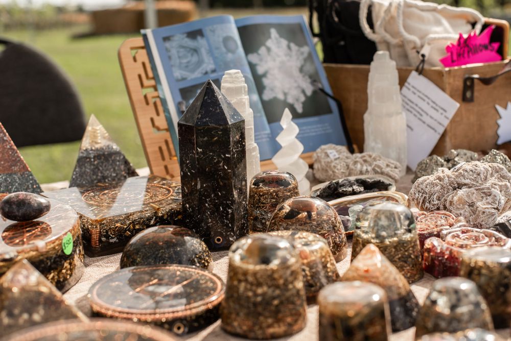 Crystal and mineral specimens displayed for sale at market vendor booth.