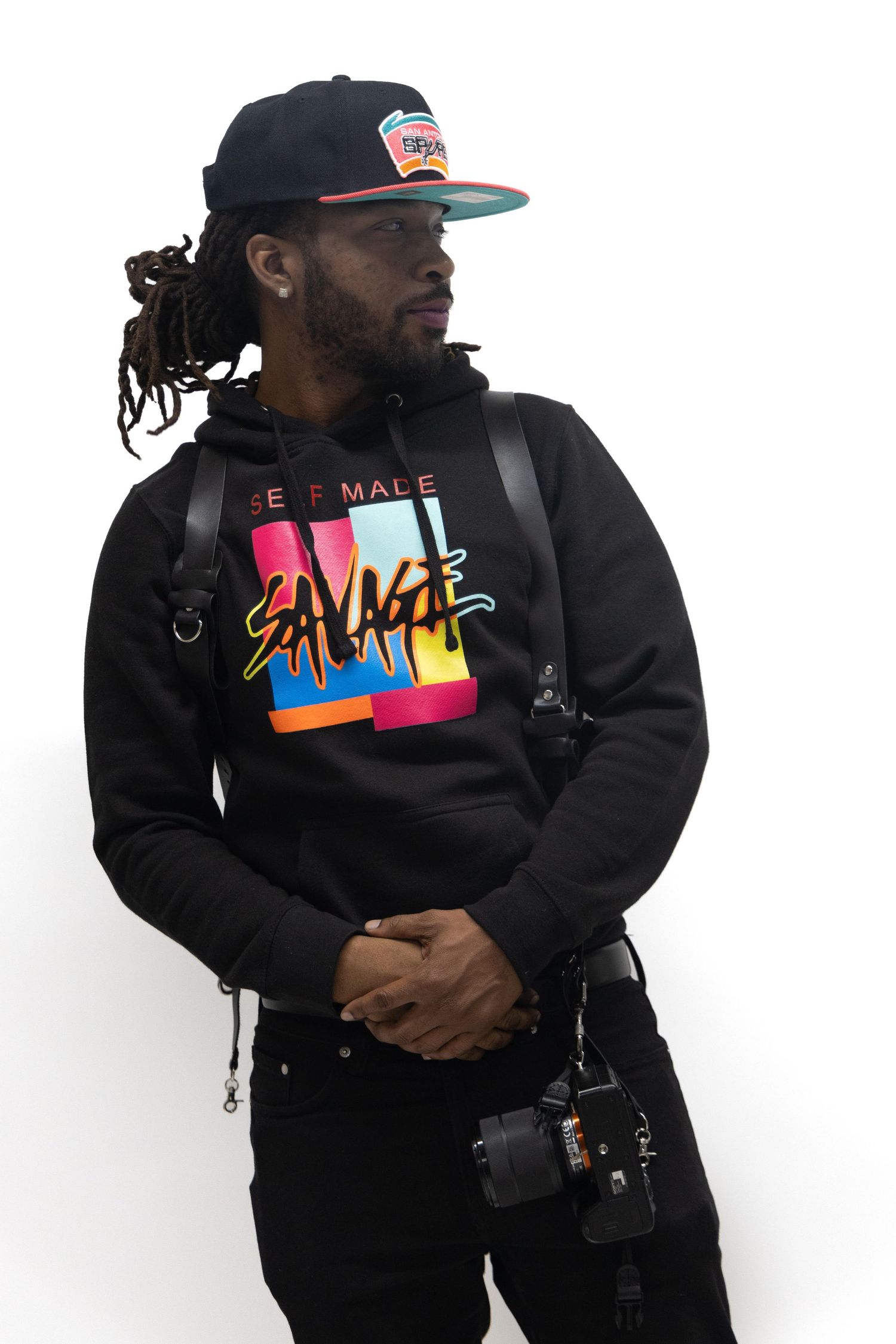 Fashion photography series featuring black hoodie with colorful graphic design.