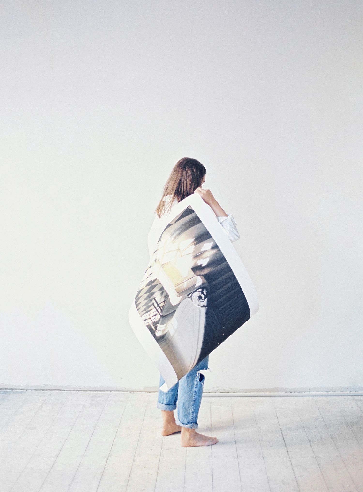 Sequence showing someone in denim jeans flipping through pages or papers against white background.