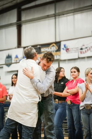 Participants in matching outfits line up for a competitive game in an indoor arena.
