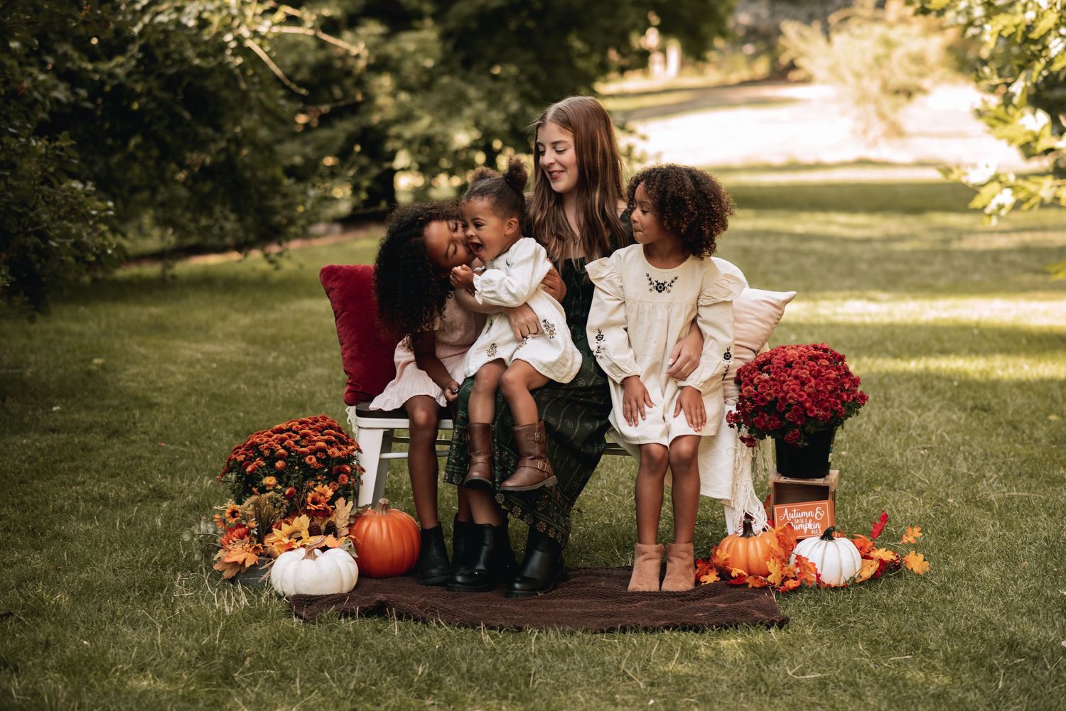 Jacki Co. Photography fall family session. Mother with her three children laughing together.