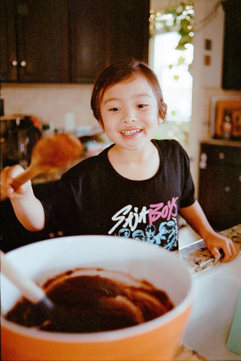 A sequence of photos showing someone enjoying chocolate fondue at a dining table with a warm glow.
