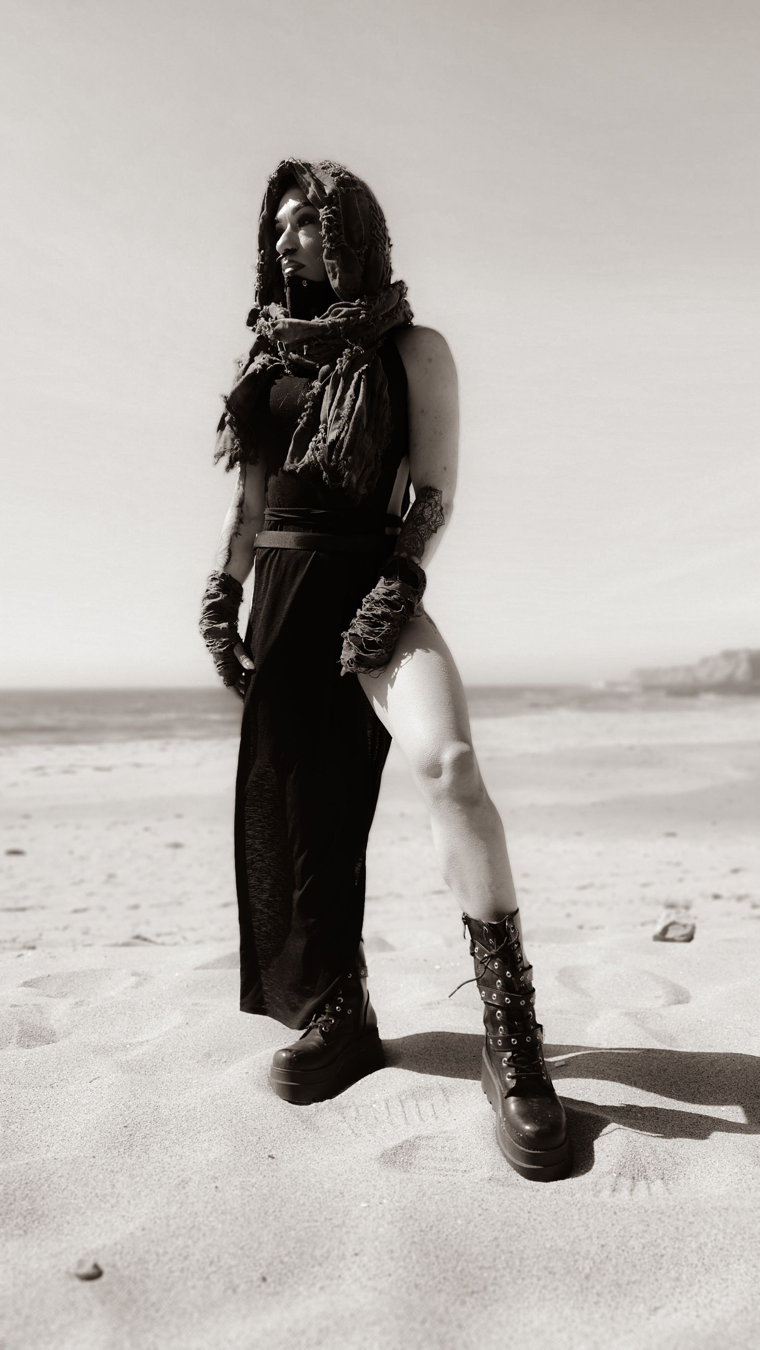 A series of black and white photographs showing someone's feet walking along a sandy beach.