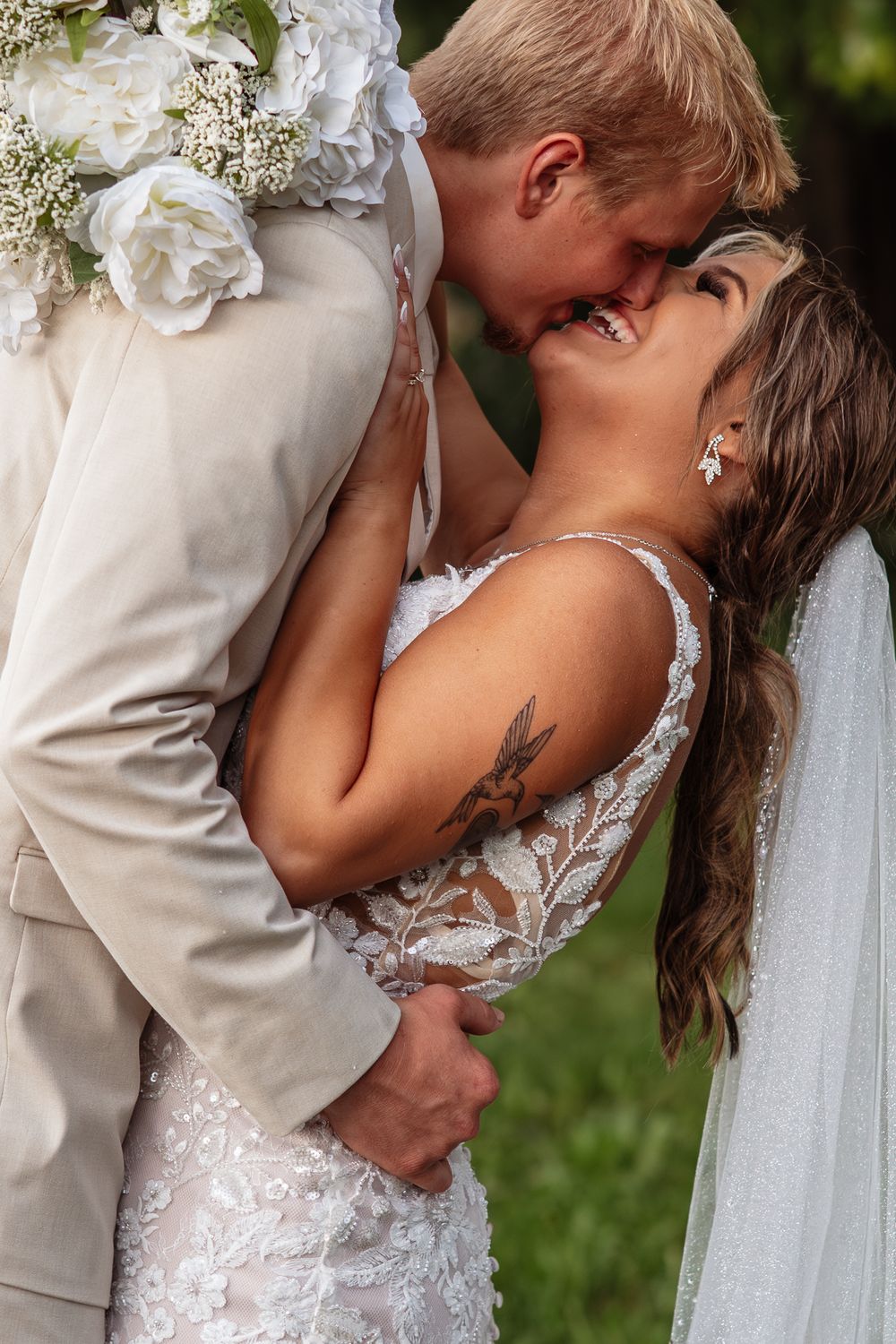 A romantic wedding sequence showing tender kisses between a couple in formal attire against a natural outdoor backdrop.